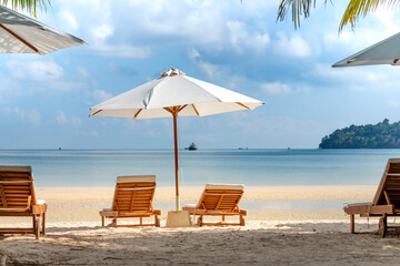 The sun loungers under umbrellas on the sandy beach on paradise island Villa Koh Rong Samloem. Cambodia. This is a small island that