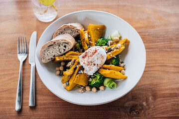 Healthy pumpkin Salad on a wooden table