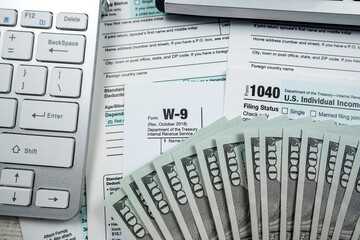 blank tax return form 1040 with dollar banknote