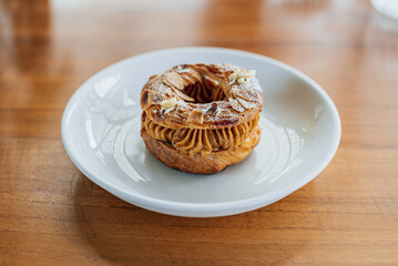 French pastry Paris Brest on a white plate