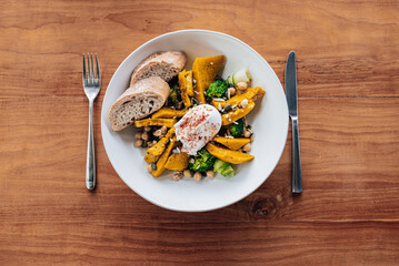 Healthy pumpkin Salad on a wooden table