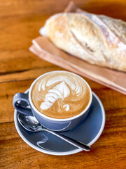 Cappuccino with bread on a wooden table breakfast