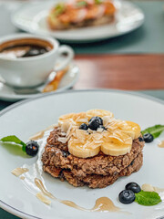Fototapeta na wymiar Healthy Breakfast Pancake oatmeal topped with bananas and blueberries