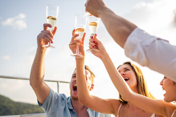 Group of diverse friends drink champagne while having a party in yacht.  - obrazy, fototapety, plakaty