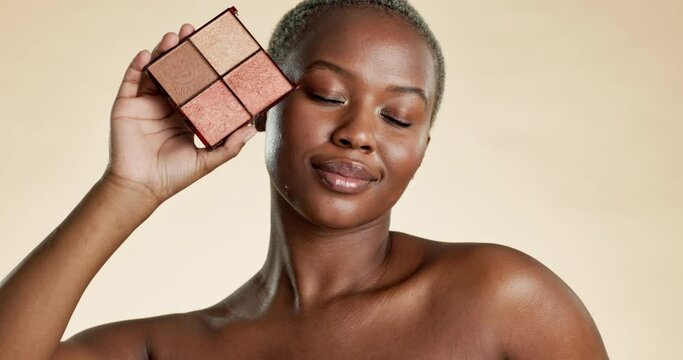 Black woman, face and makeup palette, cosmetic care and beauty product, eyeshadow or foundation on studio background. Eyes closed, female model and cosmetics, powder and skin glow, smile and content