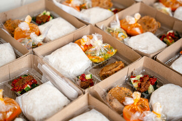 In Indonesian it is called Rice Box or Nasi kotak with perkedel kentang. Usually distributed during celebrations or catering packaging.