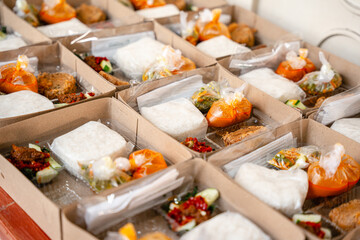 In Indonesian it is called Rice Box or Nasi kotak with perkedel kentang. Usually distributed during celebrations or catering packaging.