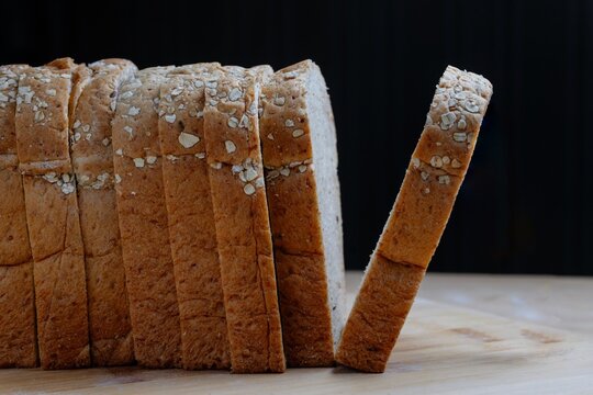 Side view of sliced whole wheat bread in a row