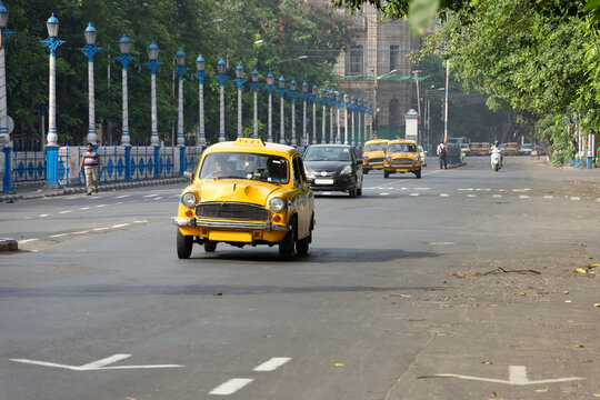 Vintage yellow taxi on the roads of Kolkata, India