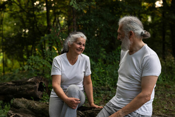 Senior man and woman are working out in the nature