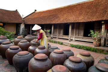  The jars of Tuong in ancient house yard, a kind of fermented bean paste made from soybean and...