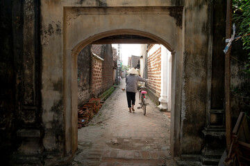 Old aged house entrance and wall made of laterite in Duong Lam ancient village, Son Tay district, Hanoi, Vietnam