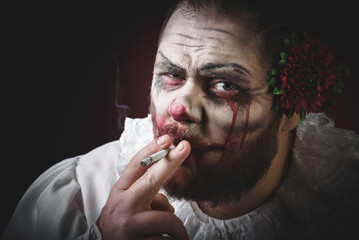 Portrait of a Scary Evil Clown.  Studio shot with horrible face art