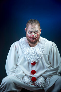 Portrait of a Scary Evil Clown.  Studio shot with horrible face art