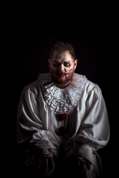 Portrait of a Scary Evil Clown.  Studio shot with horrible face art