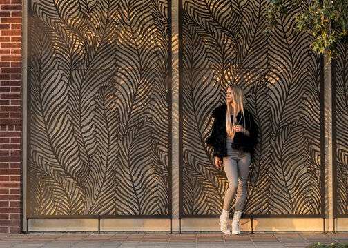 Pretty blonde in front of artwork.