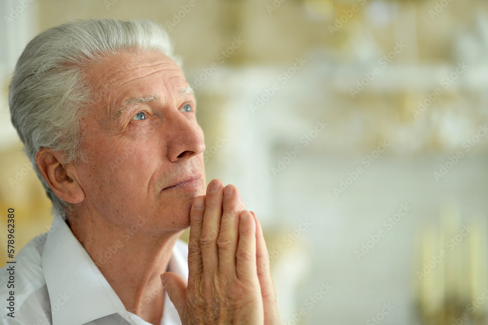 Wall mural portrait of sad thinking senior man praying