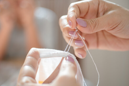 Close-up view of women sewing