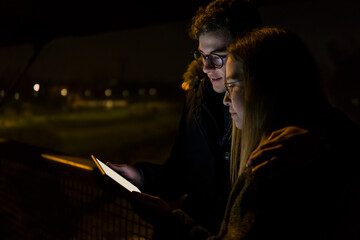 White young couple looking at a tablet device for web application