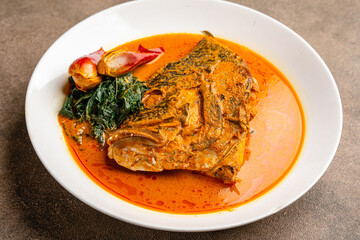 snapper curry fish head (gulai kepala ikan kakap) from padang, west sumatera, indonesia.