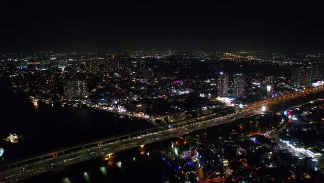 top down aerial of traffic driving over a bridge in a modern asian city of Saigon Vietnam