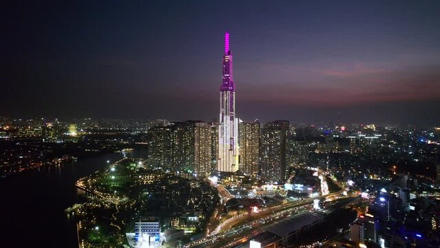 aerial zoom out of beautiful modern asian city with Landmark 81 skyline lit at night