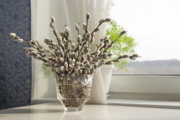 bouquet of willow branches in a crystal vase