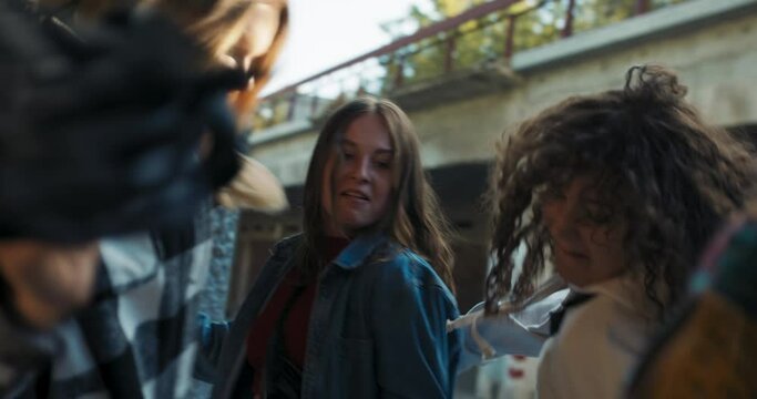 Close up shot selective focus on girls company dancing in fashionale stylish clothes making different movements action showing skills in dancing hip hop street style .