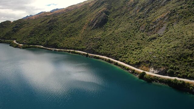 Aerial panoramic view of winding road. Popular scenic spot on Lake Wakatipu, New Zealand