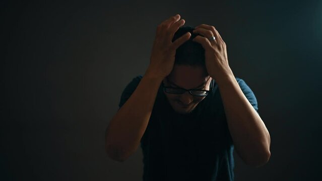 Adult Man With Glasses Visibly Frustrated, Angry, Emotional, Banging Head With Hands, Portrait