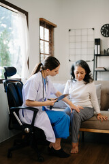 Obraz premium medical doctor holing patient's hands and comforting her.Kind doctor giving real support for patient. In home