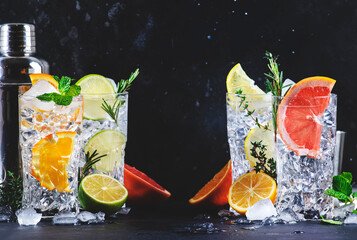 Gin tonic cocktails set. Trendy drinks with lime, lemon, grapefruit, orange, cucumber, soda and...
