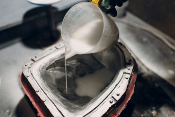 Artisan craftsman pour liquid plastic mask based on plaster cast. Gypsum mold and plastic mask...