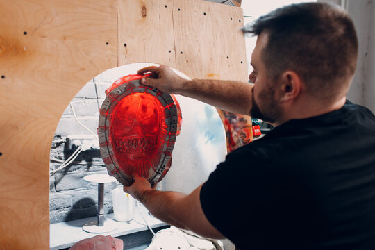 Artisan craftsman create mask based on plaster cast. Gypsum mold and plastic mask sculpting.