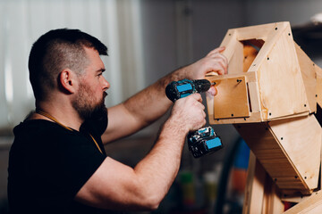 Artisan craftsman carpenter sculptor frame wooden create carcass framework. Wooden board, plywood...