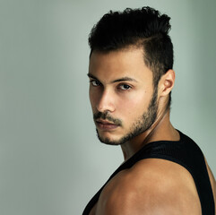Obraz premium Strong is not just physical strength, its a mindset. Studio portrait of an athletic young man posing against a gray background.