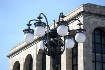 Fototapeta na wymiar Old wall street lighting, in the old town, Milan, Italy