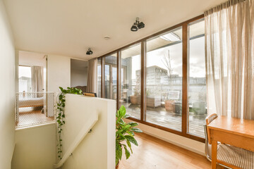 a living room with wood flooring and sliding glass doors leading to the balcony area in front of...