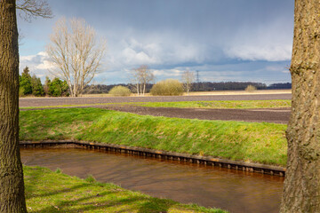 farmer land with brook on a cloudy day