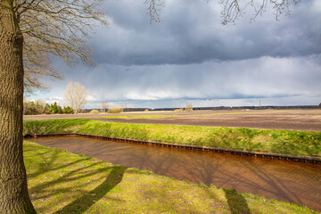 farmer land with brook on a cloudy day