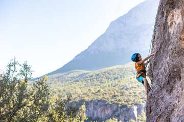 climber boy. the child trains in rock climbing.