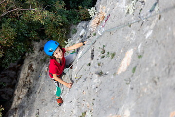 climber boy. the child trains in rock climbing.