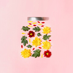 A beautiful flower arrangement in form of ar with lid on light pink background. Minimal spring concept.
