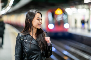 Chinese woman portrait at underground train station - obrazy, fototapety, plakaty