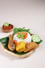 Nasi Liwet Sunda. A Traditional Sundanese Rice Served with Fried Chicken, Tofu, Tempeh, Anchovies, Chili and Broad Beans