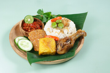 Nasi Liwet Sunda. A Traditional Sundanese Rice Served with Fried Chicken, Tofu, Tempeh, Anchovies, Chili and Broad Beans
