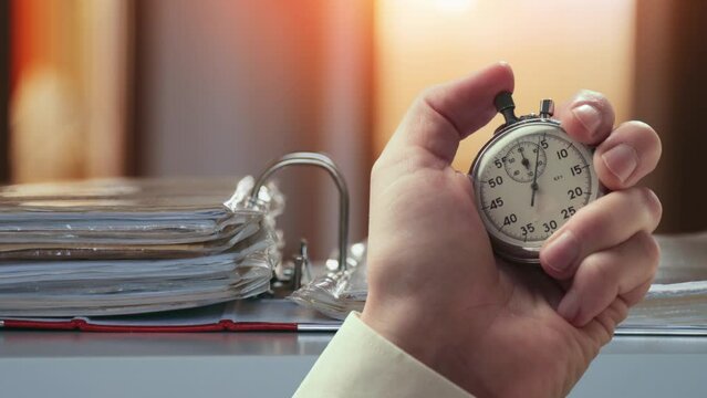 Animation of document case on a table and stopwatch in a hand