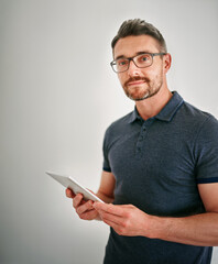 You name it, theyve got an app for that. a man using a digital tablet against a gray background.