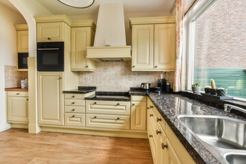 a kitchen with white cabinets and black granite counter tops in the center of the image is taken...