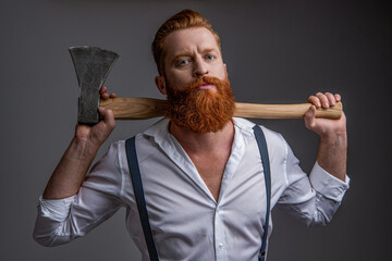 masculinity of bearded man with axe in studio. masculinity of man with axe